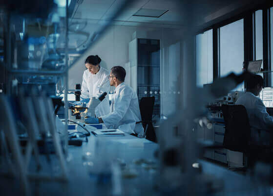 Two scientists in a biopharmaceutical laboratory