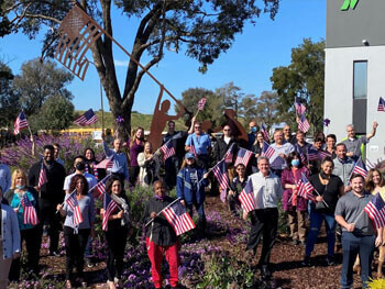 Air Systems employees holding American flags for Veterans Day